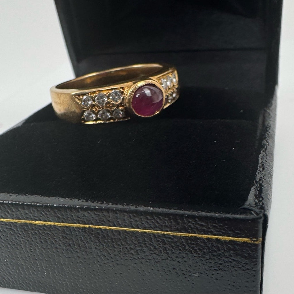 Cabochon Ruby ring set with diamond stones set in an 18 karat gold band
