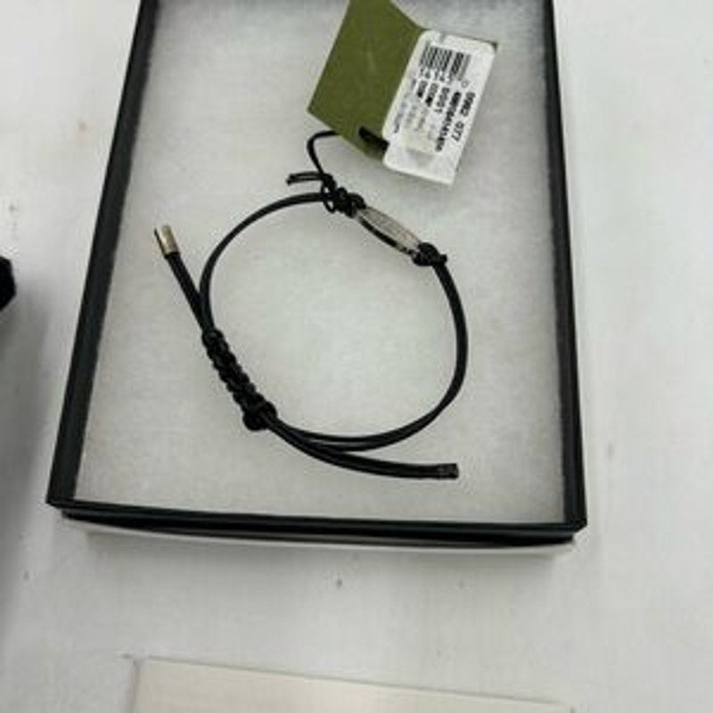 Gucci, black leather cord bracelet with sterling silver logo engraved plaque