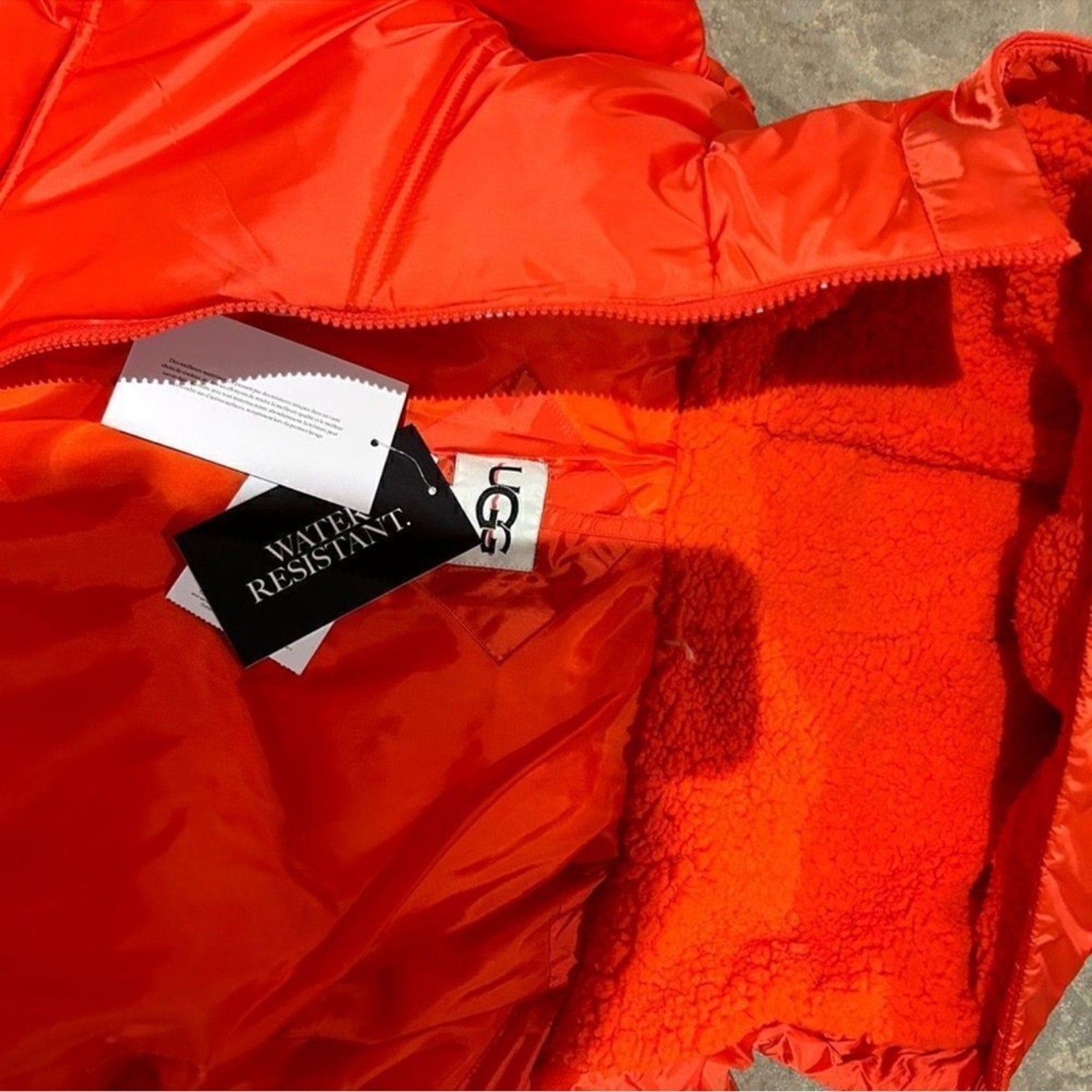 Women's UGG water resistant red puffer jacket, size Large
New With Tags