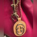 Gucci, gold logo,/tan leather, bag charm 
W/removable gold chain, add 2 any bag