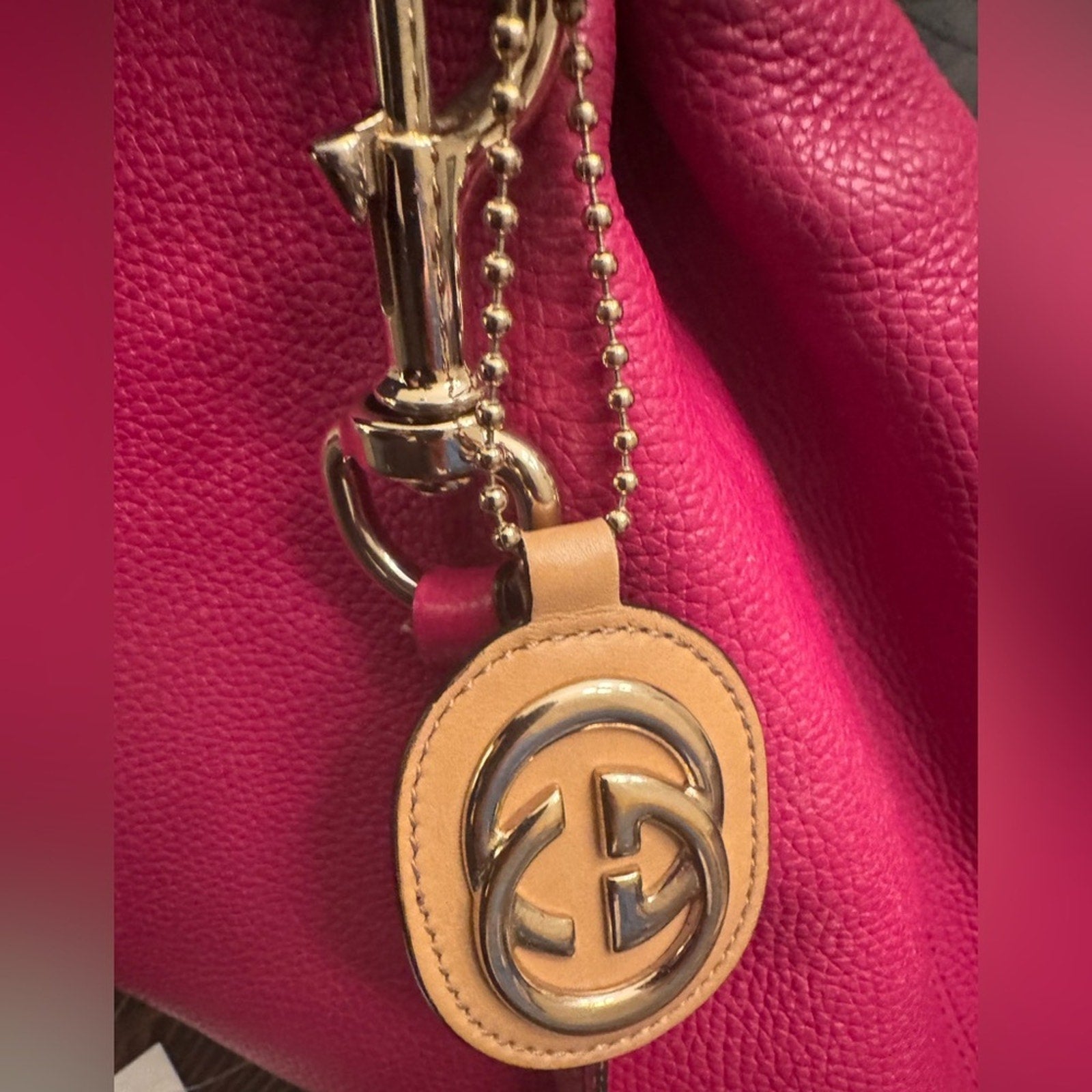 Gucci, gold logo,/tan leather, bag charm 
W/removable gold chain, add 2 any bag