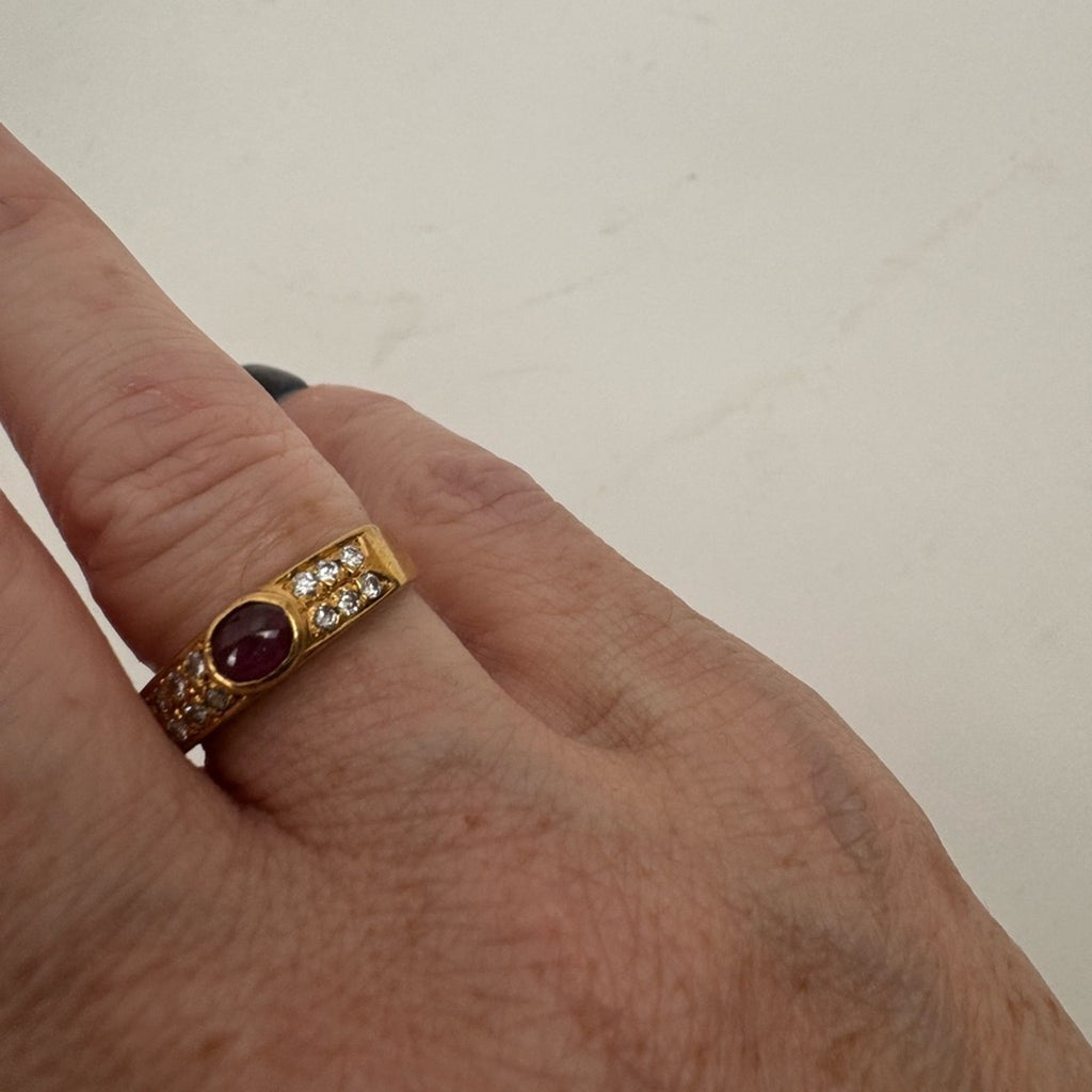 Cabochon Ruby ring set with diamond stones set in an 18 karat gold band