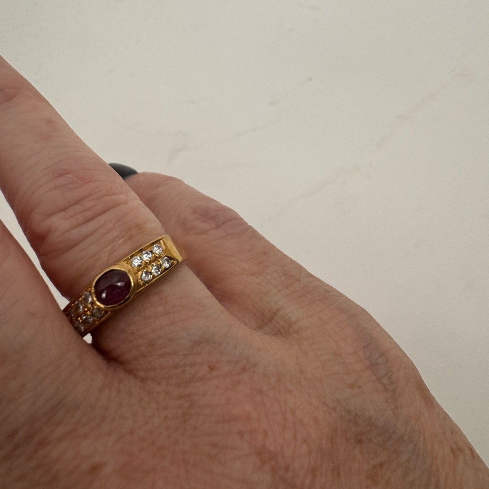 Cabochon Ruby ring set with diamond stones set in an 18 karat gold band