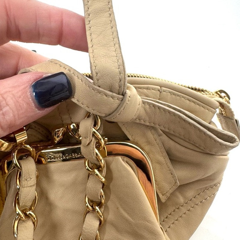 Dolce and Gabbana miniature leather bag with kiss lock, plaque and gold hardware