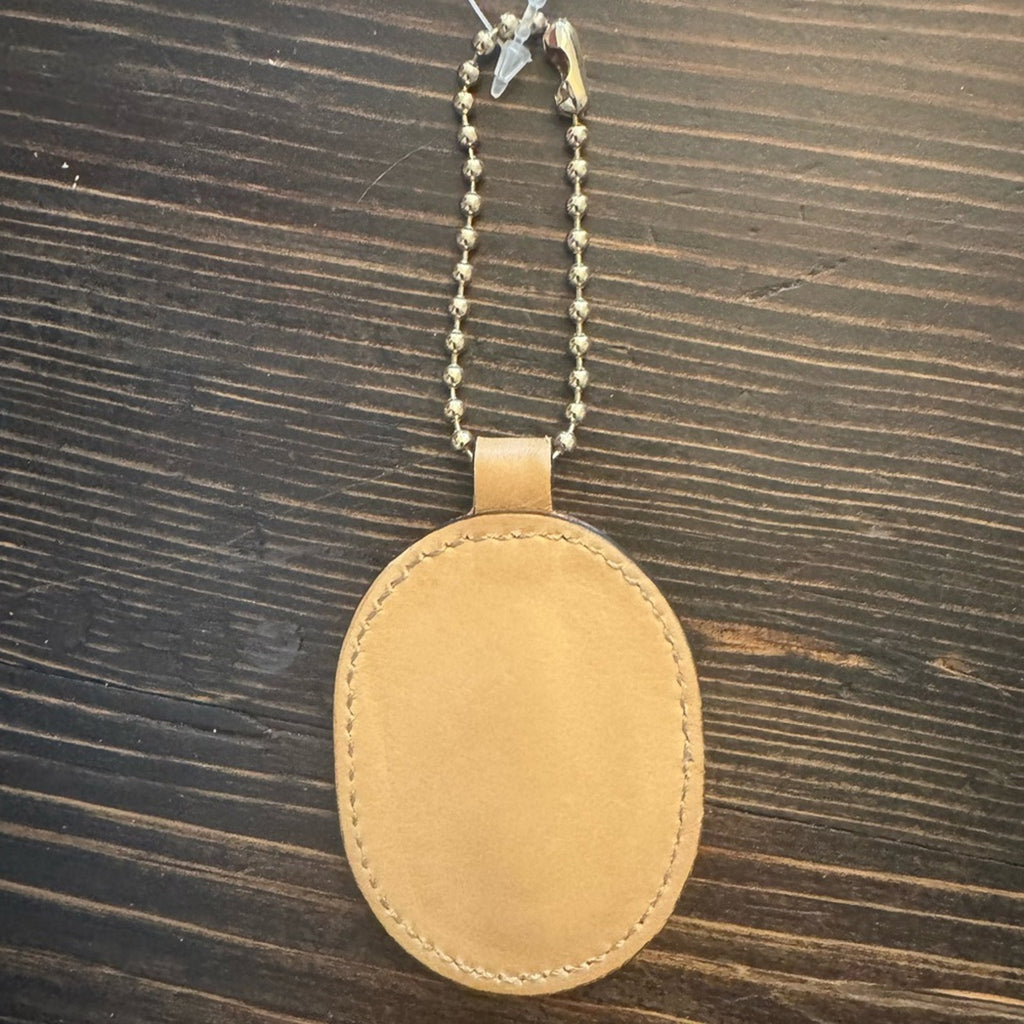 Gucci, gold logo,/tan leather, bag charm 
W/removable gold chain, add 2 any bag