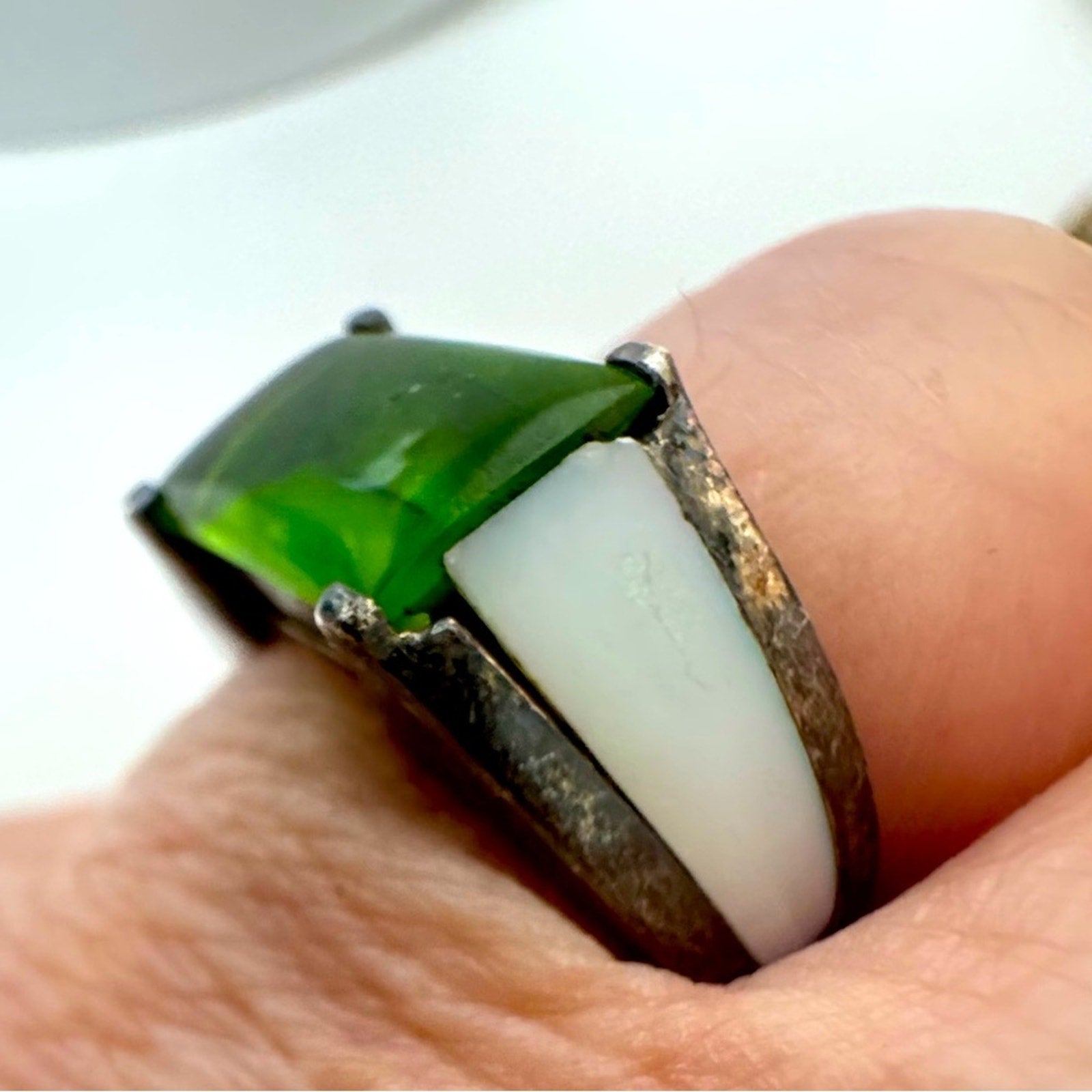 Lilly, blue featuring center peridot w/mother of pearl inlay in a silver setting