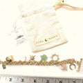 LUNA NORTE gold tone toggle charm bracelet. Semi-precious stones