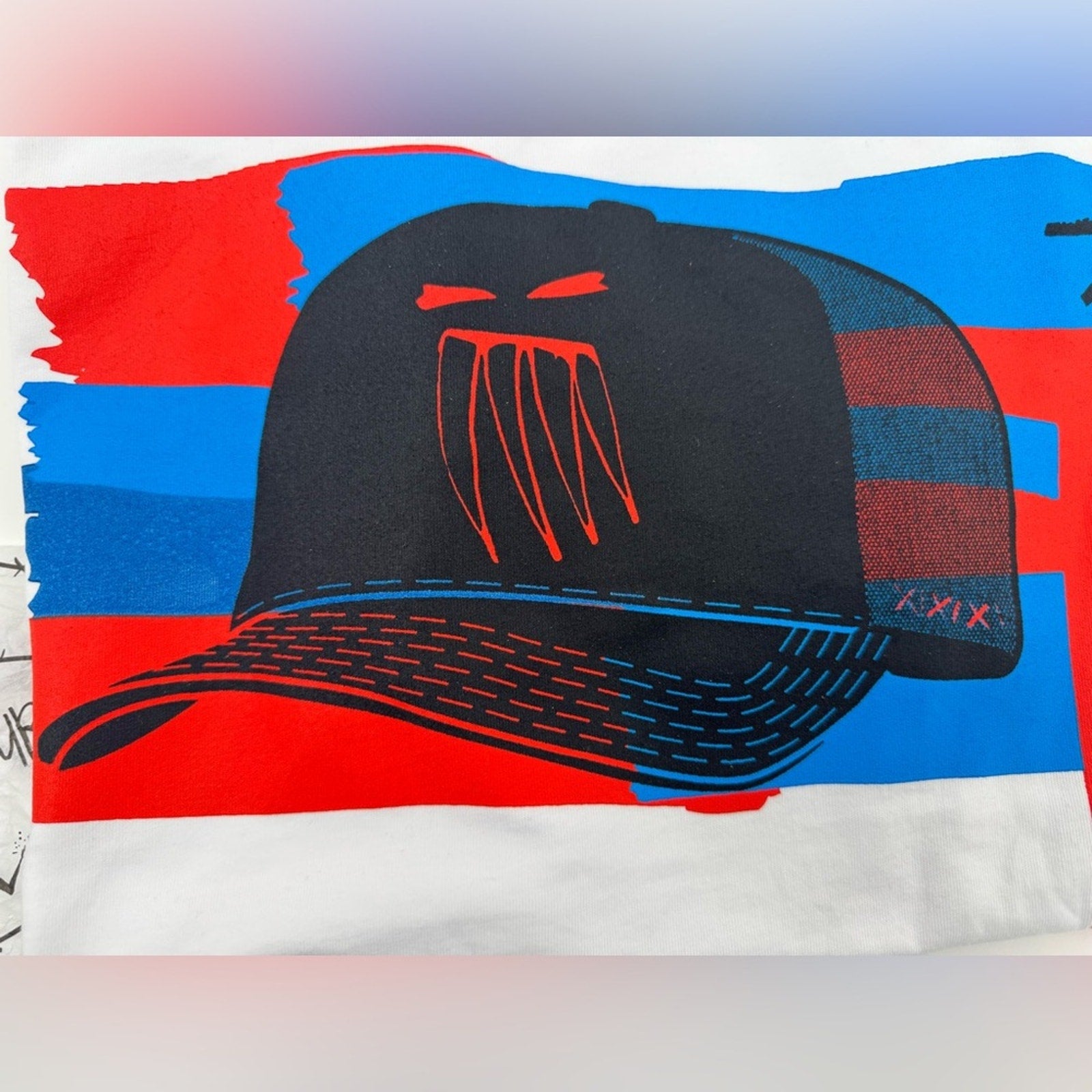 Men’s Reigning Fury-Blue Ghost of Trucker T White
Size L, limited edition NWT’s