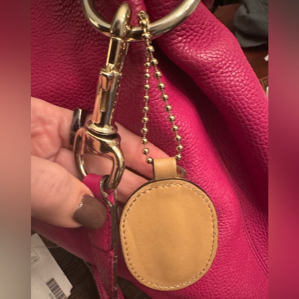 Gucci, gold logo,/tan leather, bag charm 
W/removable gold chain, add 2 any bag