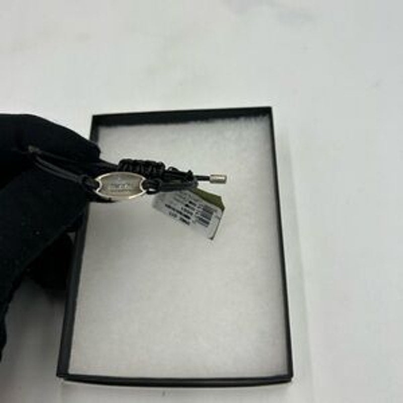 Gucci, black leather cord bracelet with sterling silver logo engraved plaque