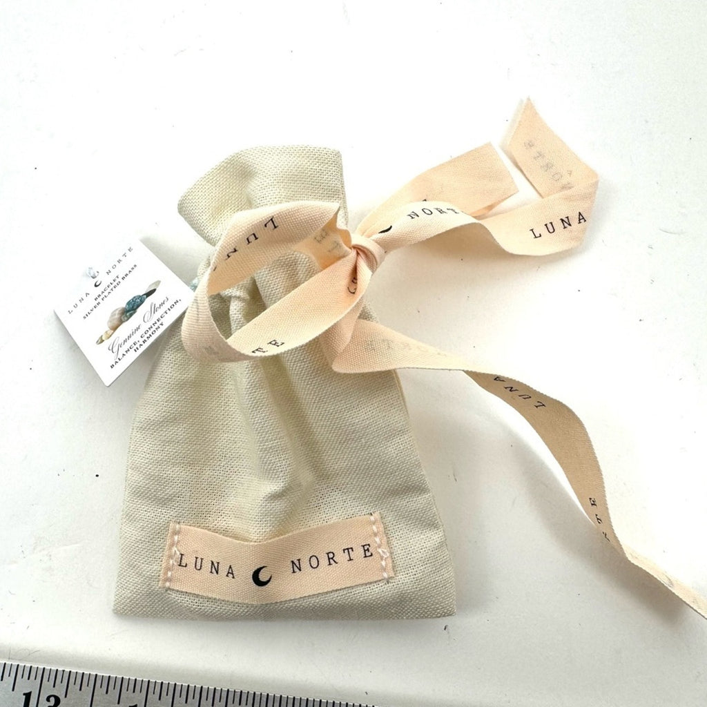 LUNA NORTE gold tone toggle charm bracelet. Semi-precious stones