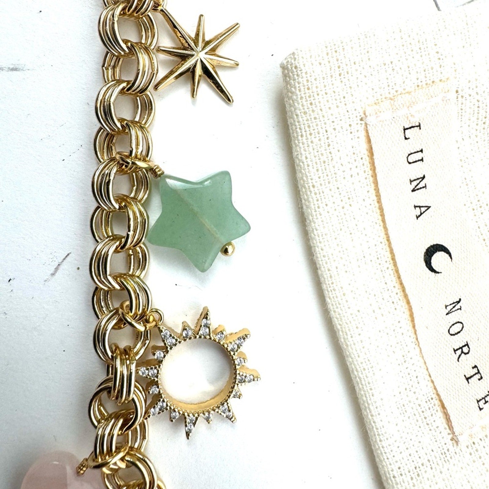 LUNA NORTE gold tone toggle charm bracelet. Semi-precious stones
