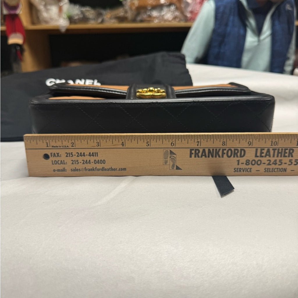 Chanel Black and Tan flap bag with gold hardware/adjustable strap/back pocket