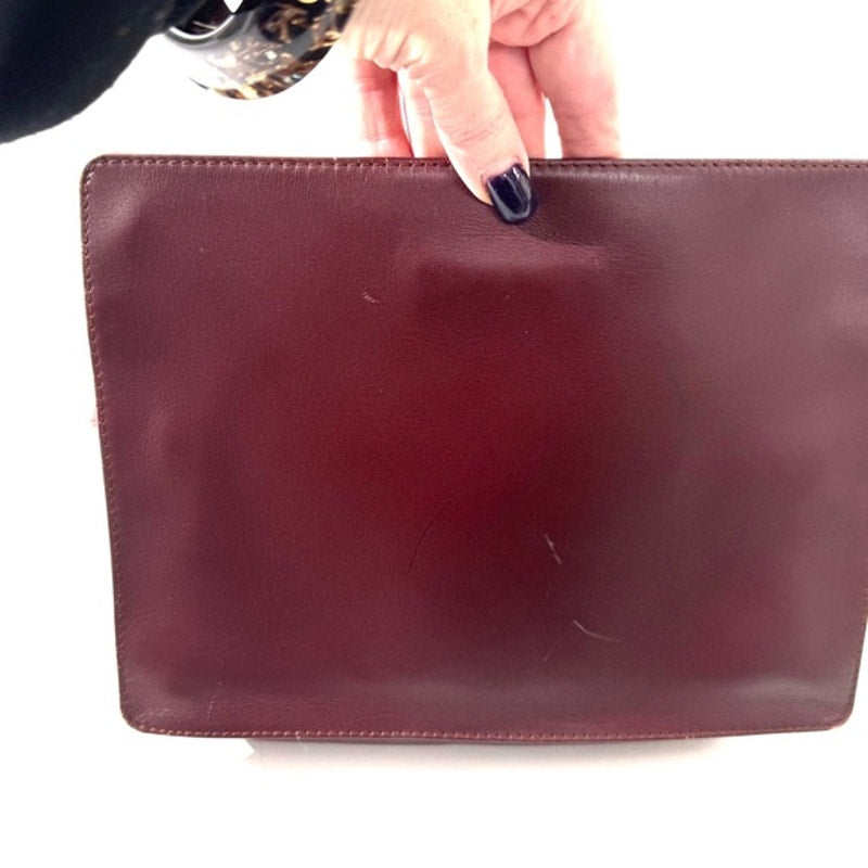 Cartier Burgundy Wristlet pouch with exterior front pocket w/interior peeling