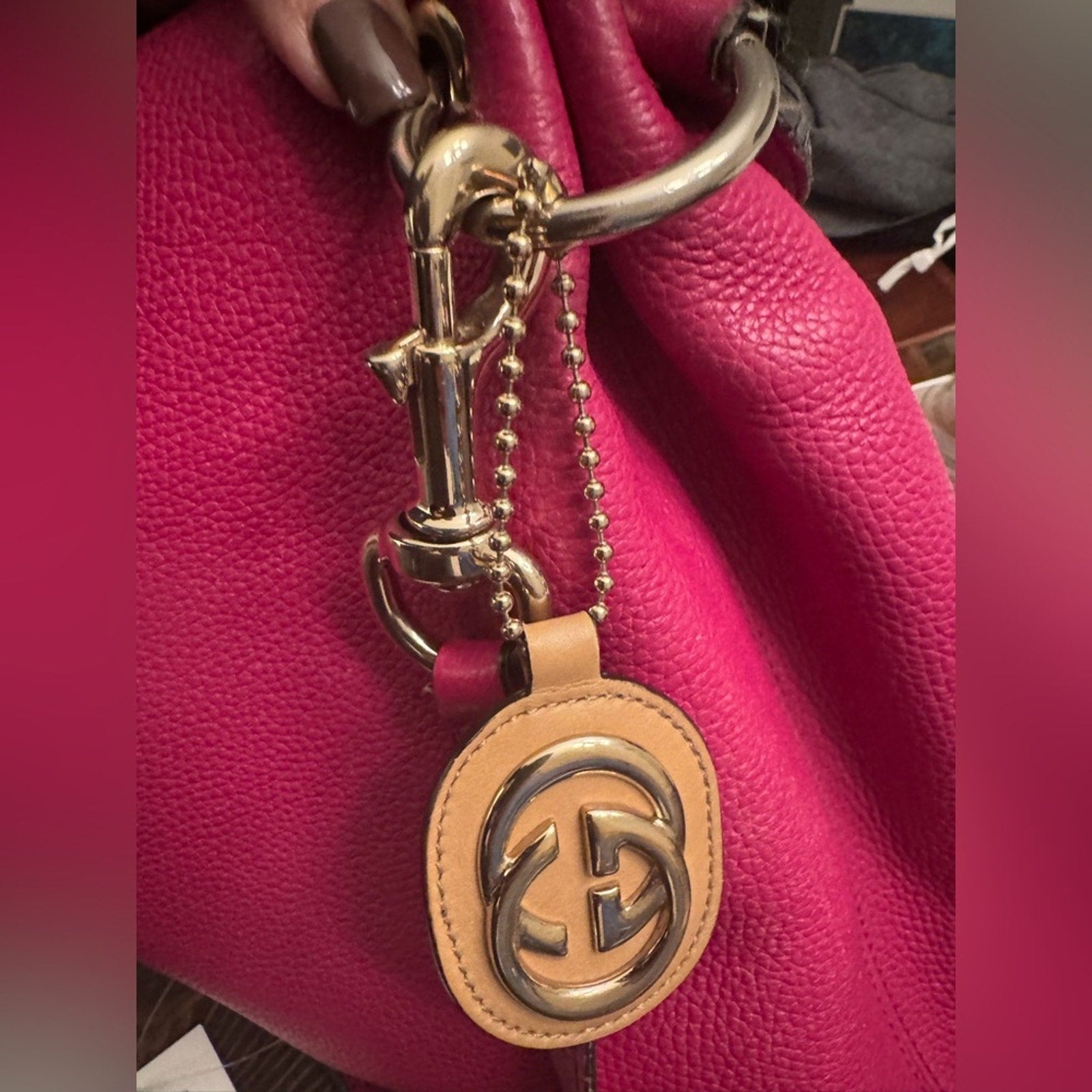 Gucci, gold logo,/tan leather, bag charm 
W/removable gold chain, add 2 any bag
