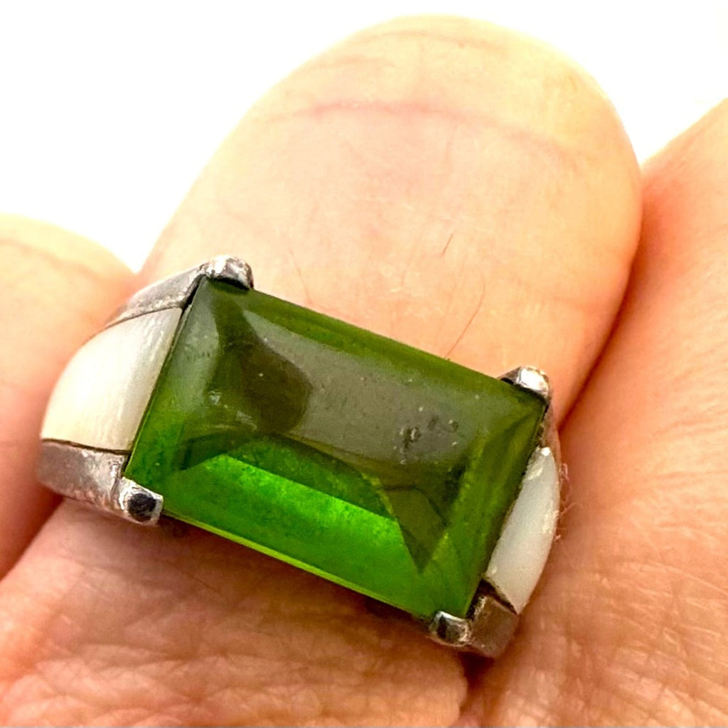 Lilly, blue featuring center peridot w/mother of pearl inlay in a silver setting