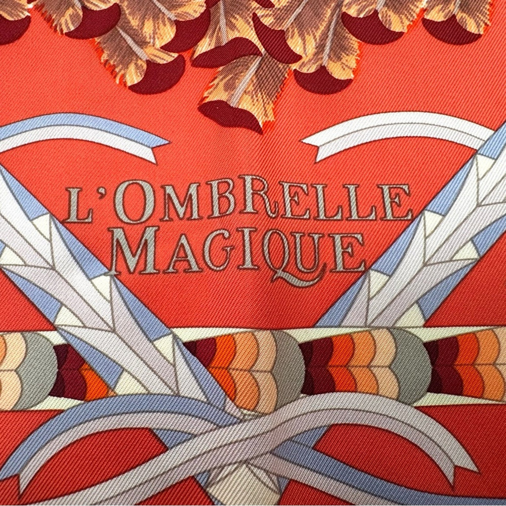Hermes, silk scarf. The theme is the magic umbrella, coral colorway w/vignettes.