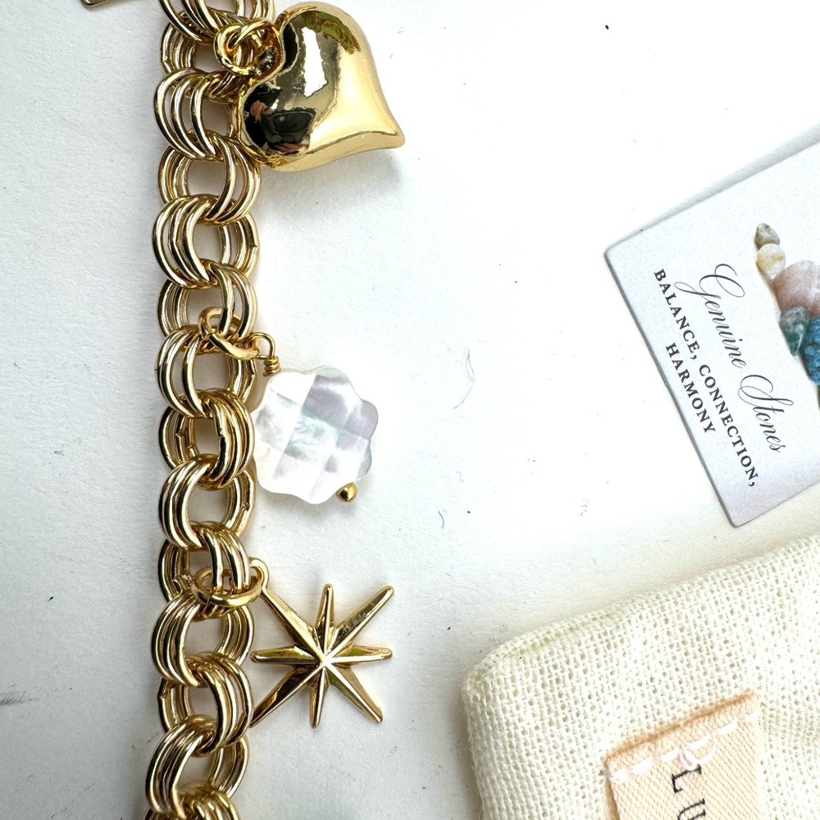 LUNA NORTE gold tone toggle charm bracelet. Semi-precious stones