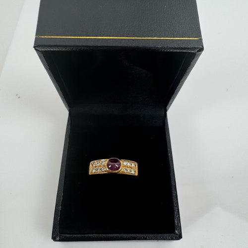 Cabochon Ruby ring set with diamond stones set in an 18 karat gold band
