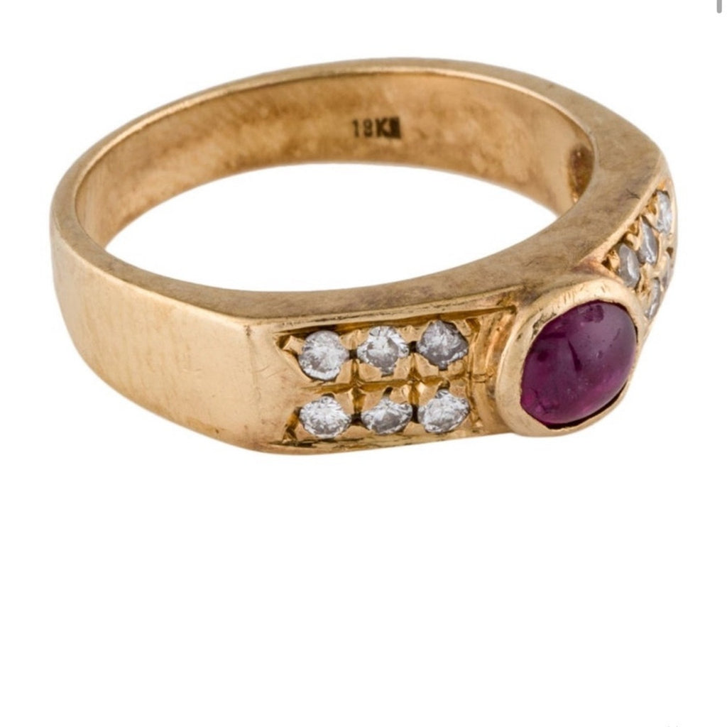 Cabochon Ruby ring set with diamond stones set in an 18 karat gold band