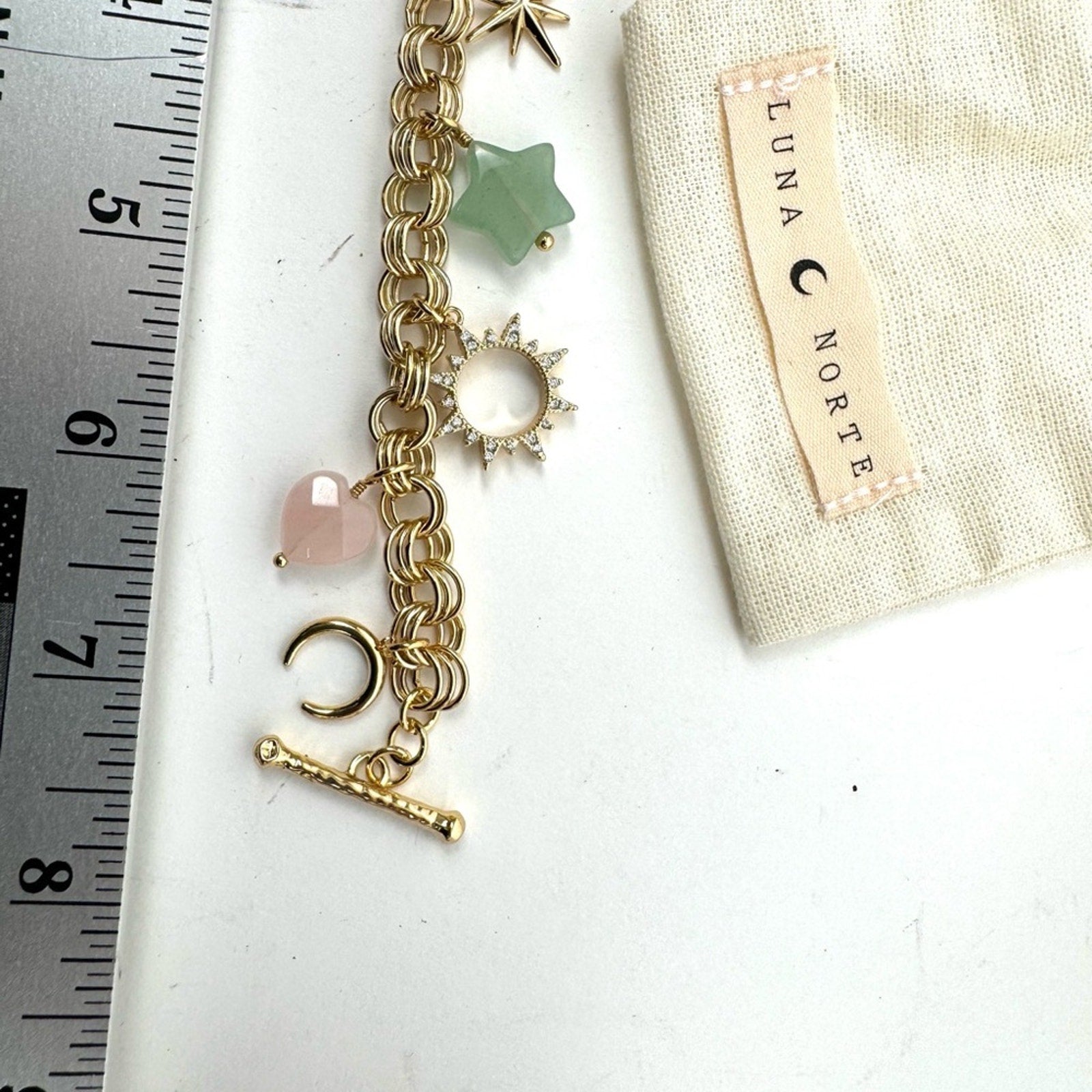LUNA NORTE gold tone toggle charm bracelet. Semi-precious stones