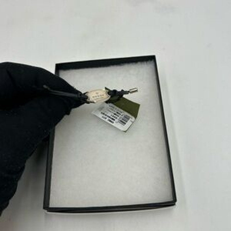 Gucci, black leather cord bracelet with sterling silver logo engraved plaque