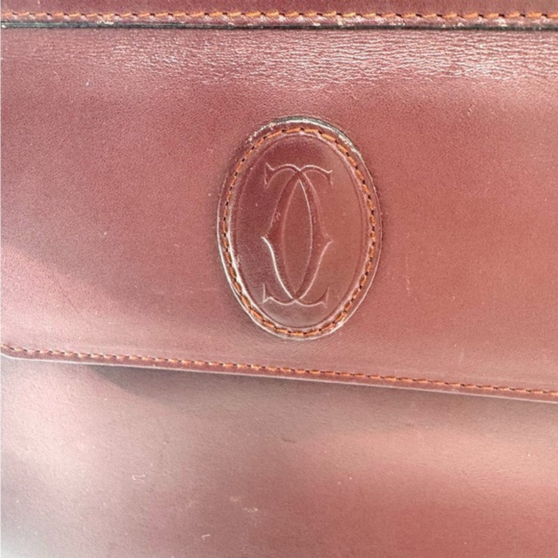 Cartier Burgundy Wristlet pouch with exterior front pocket w/interior peeling